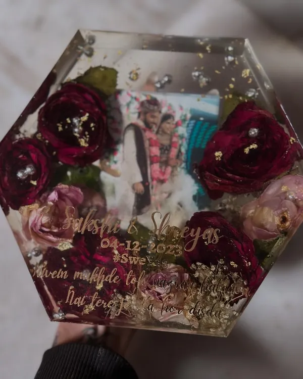 A hexagon-shaped keepsake preserving deep red wedding roses and baby's breath. This piece includes the couple's photo, names, and wedding date, making it a complete memory block.