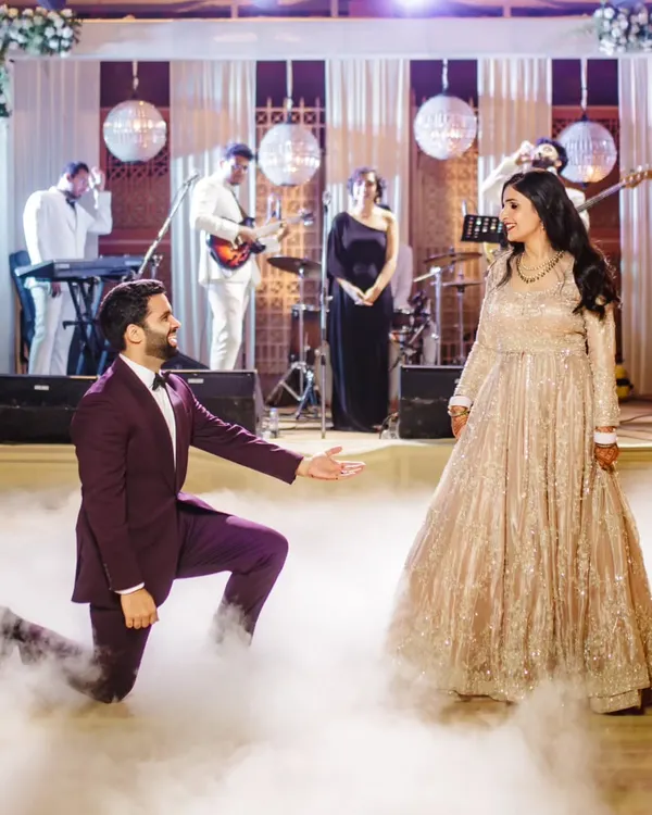 A classic romantic pose to start the performance. We choreograph beautiful moments like this groom's proposal mid-dance, set against a live band and a smoky floor for that extra dreamy effect.