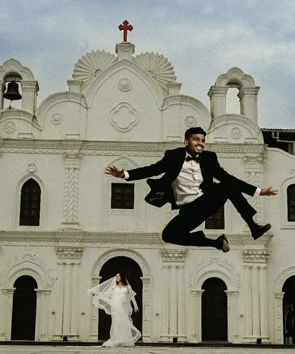 The pure joy of a 'just married' moment. I love capturing this kind of spontaneous energy, like the groom's celebratory jump outside the church. It's these real, unposed moments that you'll cherish.