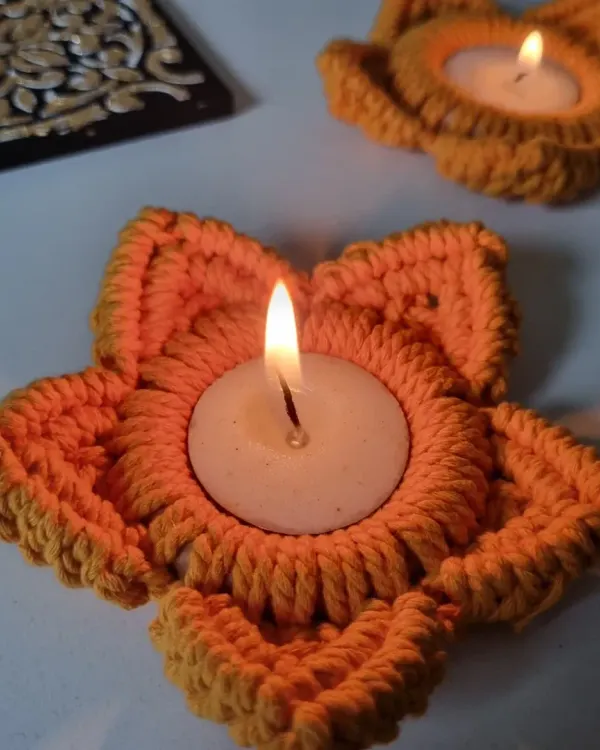 Light up your home with my macrame tealight holders. Shaped like a flower, these orange holders cast a warm, inviting glow, perfect for Diwali or any festive occasion.