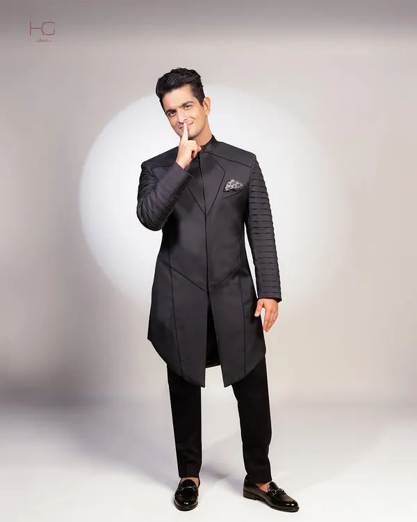 For Anant and Radhika's wedding festivities, I designed this 'superhero' inspired achkan set for Ranveer Allahbadia. The structured panels and pleated sleeves create a powerful, futuristic silhouette.