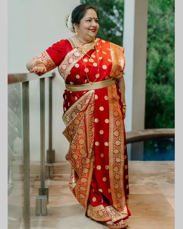 The beautiful mother of my Bengali bride, looking absolutely regal in her traditional red and gold saree. We gave her a classic makeup look with a defined eye, a red bindi, and an elegant hair bun to complete her look.