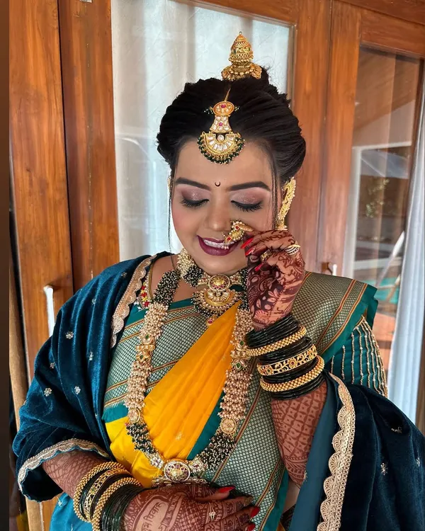 My beautiful bride looking regal in her Nauvari. The look is complete with a 'jodvi' on her forehead, a classic 'nath', and subtle yet glowing makeup that highlights her features.
