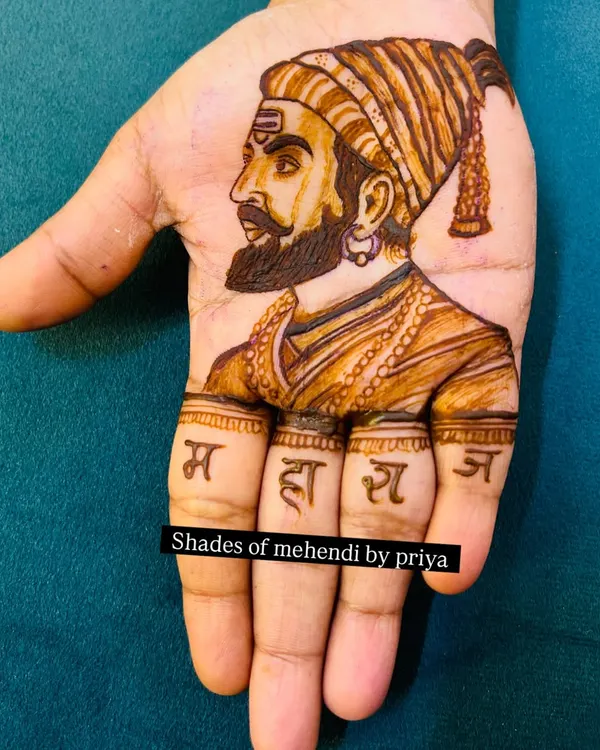 A powerful portrait of Chhatrapati Shivaji Maharaj on the palm. The word 'Maharaj' is written on the fingers, and the detailed shading captures his iconic profile.