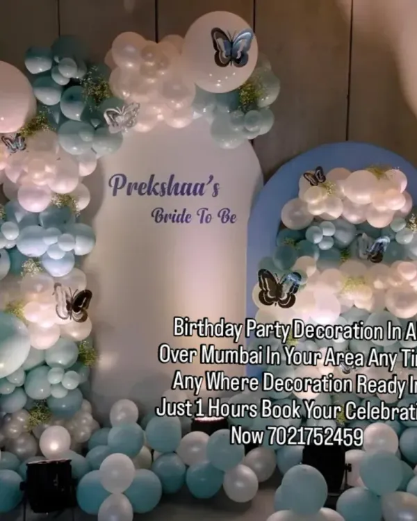 Celebrating a "Bride to Be" with this beautiful blue and white butterfly-themed decoration. The custom arch backdrops and soft balloon colors create an elegant setting for a bridal shower.