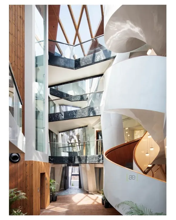 This is the heart of the Cleft House, an award-winning project where we explored the idea of a home as a sculpted monolith. The central atrium, with its helical staircase, is designed to draw in light and connect all levels of the home, creating a dynamic interplay of shared and private spaces.