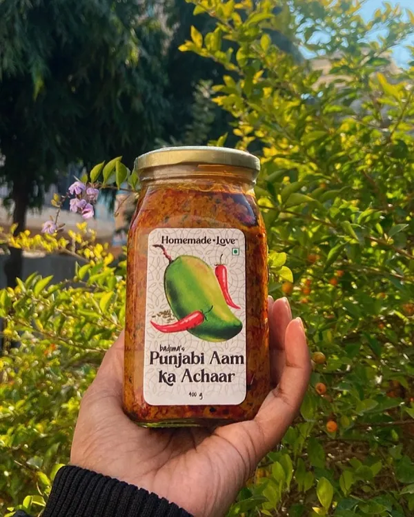 Our Punjabi Aam ka Achaar, held in the winter sun. This is our bestseller, made with a traditional recipe that has been in our family for generations. It's the perfect balance of spicy and tangy.