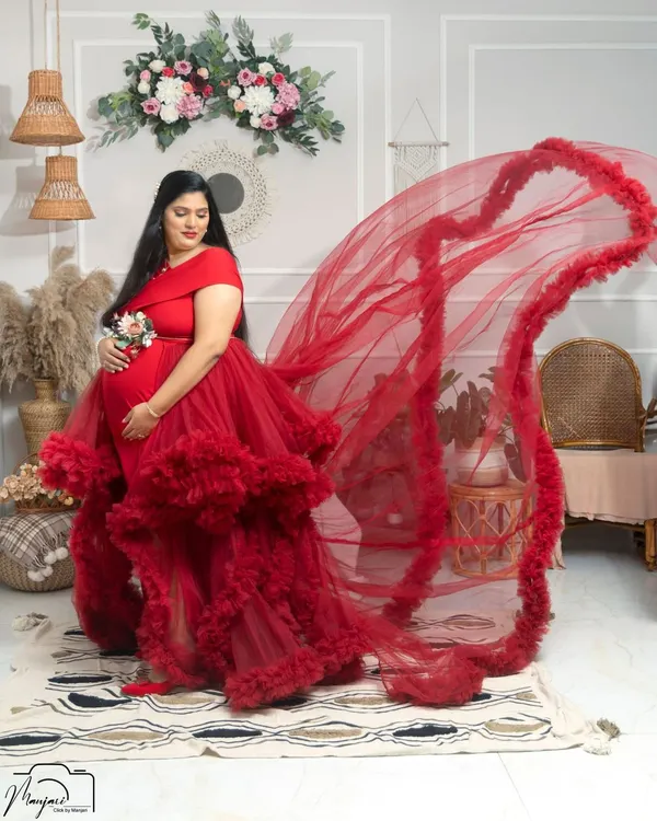 A glimpse of our stunning red ruffled gown with a dramatic flowing train, perfect for making a bold and beautiful statement.