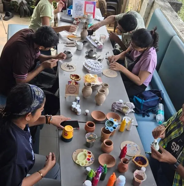 A high-angle view of a full painting workshop at my studio. You can see the variety of pots and paints available for everyone to choose from.