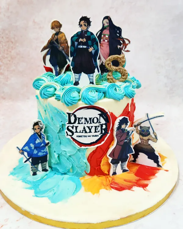 This Demon Slayer theme cake captures the series' dynamic art style with characters set against a backdrop of elemental-colored buttercream swirls.
