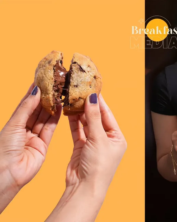 This shot is all about the "break-apart" moment, revealing the gooey, melted chocolate inside the cookie. Using a bold, solid color background makes the product the hero and creates a visually striking image for social media.