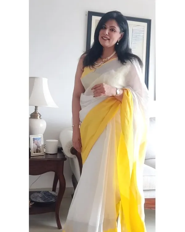This is one of my favorite looks, a beautiful white linen saree perfect for a sunny afternoon lunch in the city. For me, style is about celebrating life, and sometimes that means bringing out a treasured saree and your mother's pearls just because it feels right. This look embodies my belief in comfortable, timeless elegance.