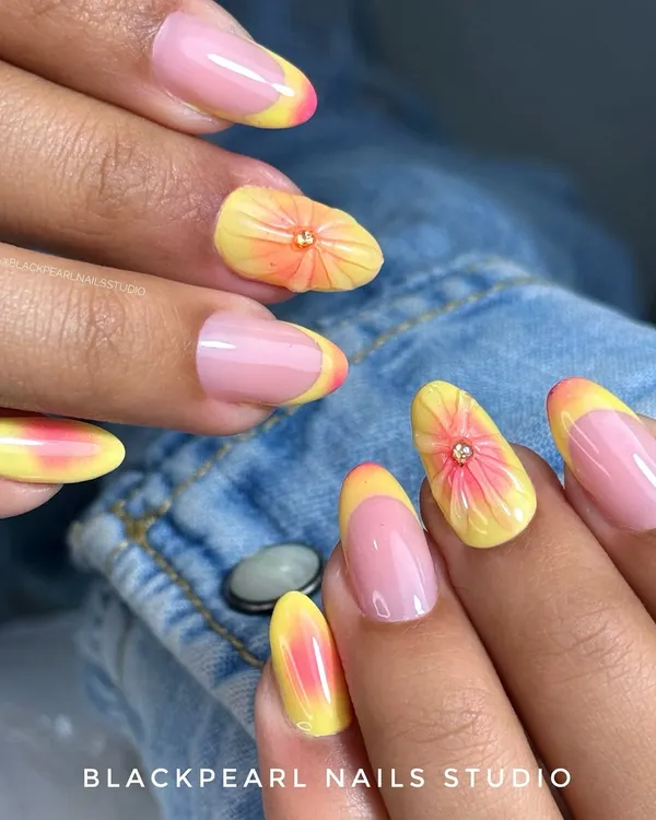This summer-ready set features a pastel yellow French tip with a dreamy aura glow. The accent nail is adorned with a soft, hand-sculpted 3D flower on a blush pink aura base, creating a fresh and fun design.