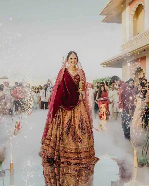 A stunning bridal entry. The bride walks down an aisle filled with smoke and sparklers, creating a magical and dramatic moment that is all about her.