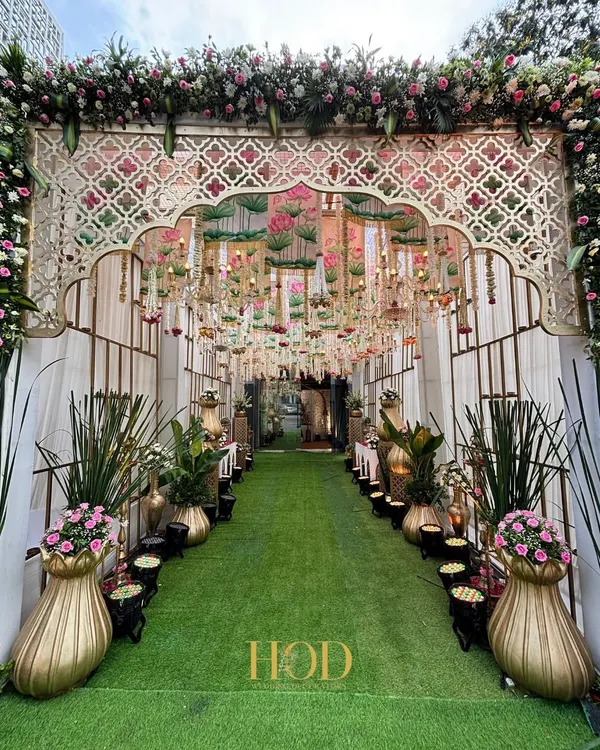This is the kind of entrance that makes your heart skip a beat. I designed this lush green walkway, framed by a grand floral arch and a canopy of chandeliers, to feel like stepping into a real-life fairytale for a beautiful wedding ceremony.