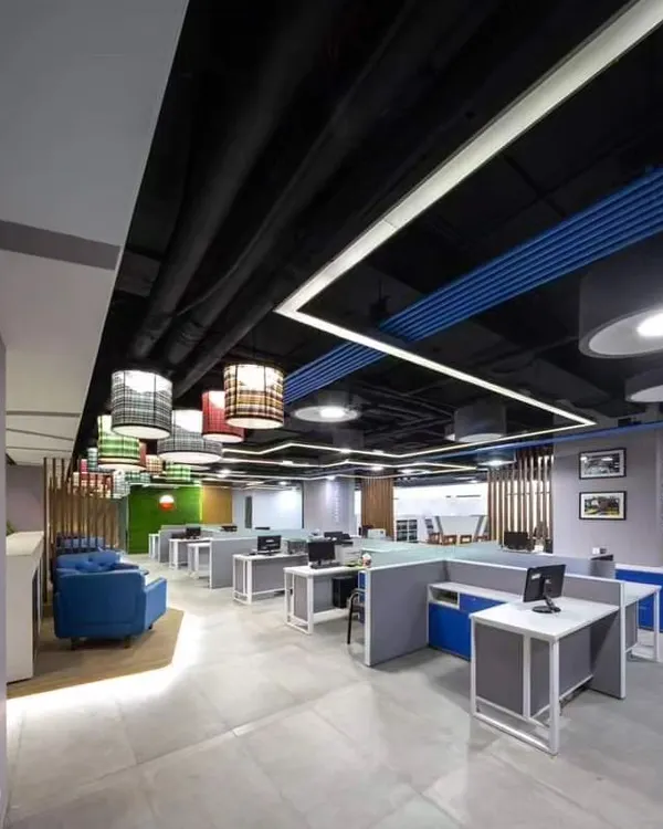 A full view of a modern office interior where I installed various acoustic treatments, including colorful ceiling baffles and sound-absorbing partitions to control noise in an open-plan layout.