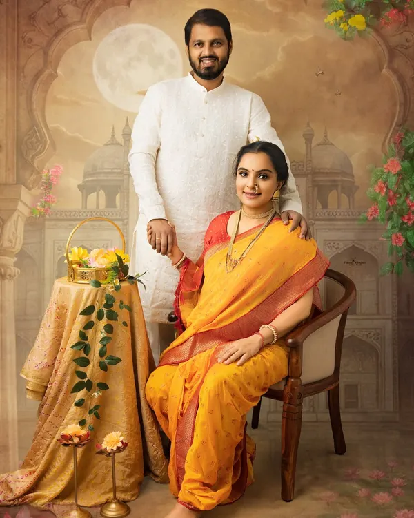 A regal couple's portrait in a vintage painting style. The mother-to-be is seated gracefully in a yellow saree, capturing a moment of traditional elegance perfect for celebrating festivals like Sankranthi.