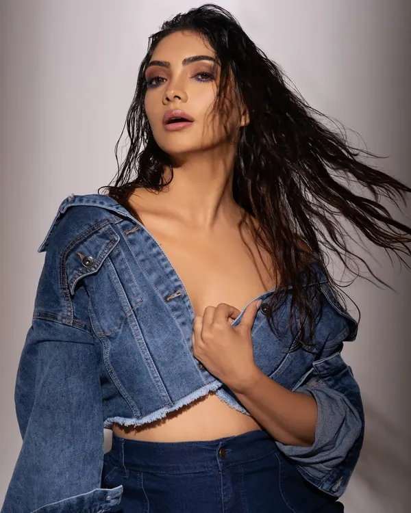 An edgy, high-fashion take on denim. The wet hair look, undone jacket, and intense expression are all part of the creative direction to create a raw and powerful image.