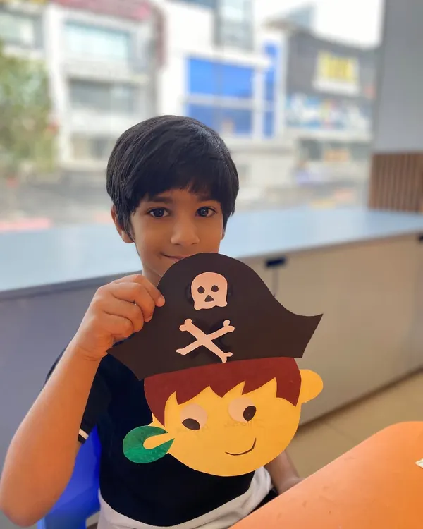 This young actor proudly displays the pirate mask he created. Our craft activities are designed to complement our drama themes, making the experience more immersive.