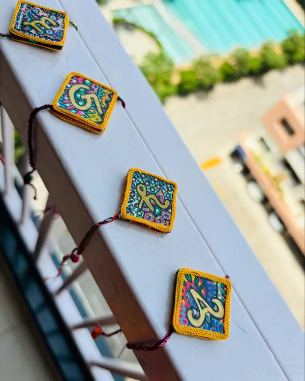 A closer look at the 'AksharBandhan' initial Rakhis. Every stroke of paint is done by hand, making each one a unique piece of art for your brother.