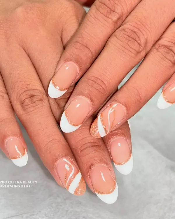 Proving that simple can be stunning. This is my take on the "clean girl" aesthetic, featuring a classic French manicure on almond nails with a delicate swirl of rose gold glitter for a subtle pop.