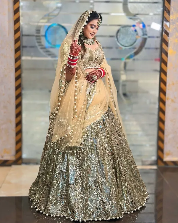 This full-length shot showcases the incredible sparkle of my gold and silver sequin lehenga. The way it catches the light is just breathtaking, making it a perfect choice for a sangeet or reception night.