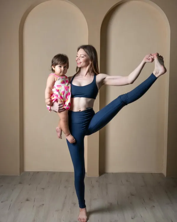 This is what my practice looks like now, and I wouldn't have it any other way. Holding my daughter while in Utthita Hasta Padangusthasana shows how yoga adapts to life. Motherhood has taught me that balance is not just about holding a pose, but about integrating my practice into my life as a new mom.