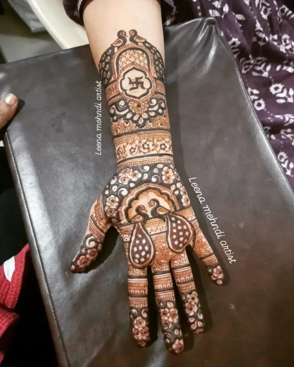 This full-arm bridal design showcases a blend of traditional motifs, including auspicious peacocks and a central Swastika. The intricate line work, detailed fillers, and balanced composition are key skills I teach in my advanced workshops.