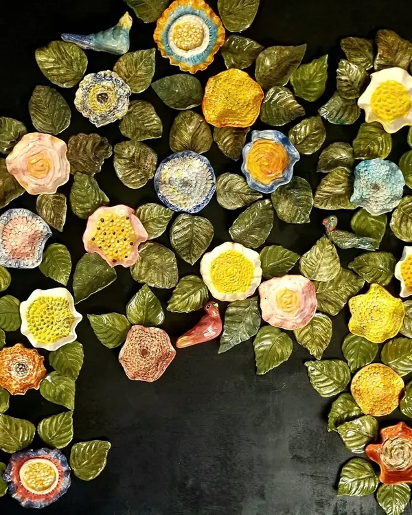 This is my interpretation of the Tree of Life, a large 4 by 3 foot ceramic wall mural. Inspired by Kalamkari embroidery, every single flower, leaf, and bird is handmade and painted to be unique, coming together to create a vibrant, textured piece of wall art.