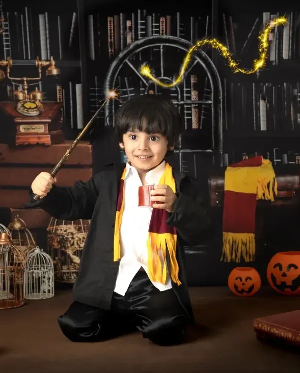 A young wizard casts a spell with a magical light trail effect. My themed sessions include creative editing to add an extra layer of fantasy.