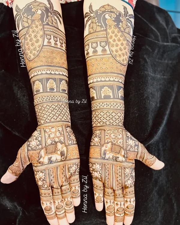 A classic and bold bridal design. The combination of majestic peacocks on the arms and elephants on the palms creates a look that is both traditional and powerful.