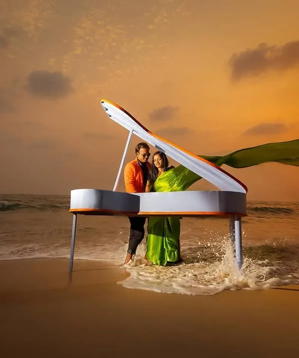 A grand piano on the beach at sunset. We believe in creating surreal and unforgettable concepts for your save the date or pre-wedding shoot, making your announcement truly stand out.