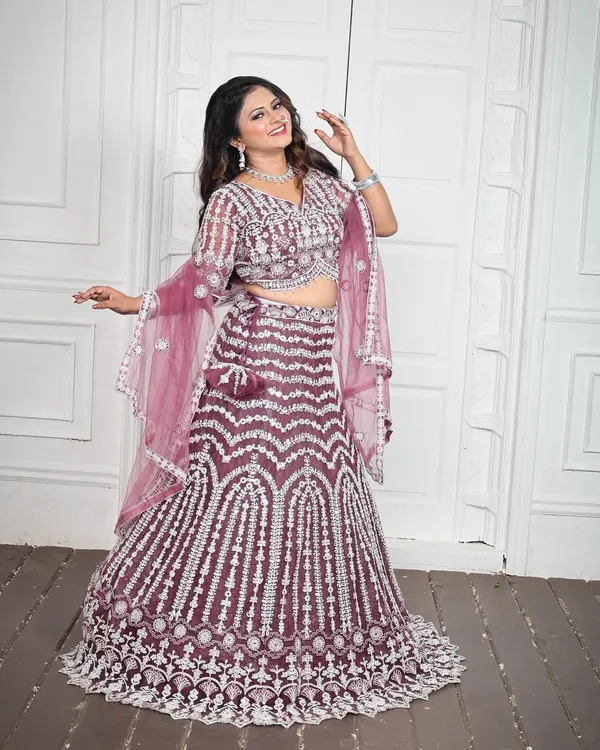 This gorgeous wine-colored lehenga is one of my most requested pieces for engagements and sangeet nights. The intricate silver embroidery and mirror work catch the light beautifully, and it comes with a complete matching jewellery set for a full, ready-to-wear look.