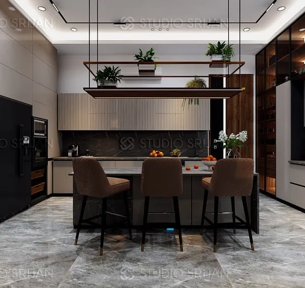 This kitchen in Alameda, Gurgaon, is designed for a seamless cooking and social experience. The large central island provides ample workspace and seating, while the sleek, handle-less cabinets and integrated appliances maintain a clean, modern aesthetic.