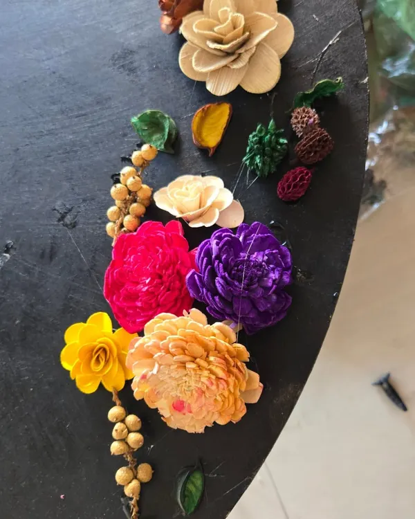 A beautiful arrangement of sola wood flowers and dried botanicals, showcasing some of the craft materials we use. Our workshops are a hands-on experience with a diverse range of art supplies.