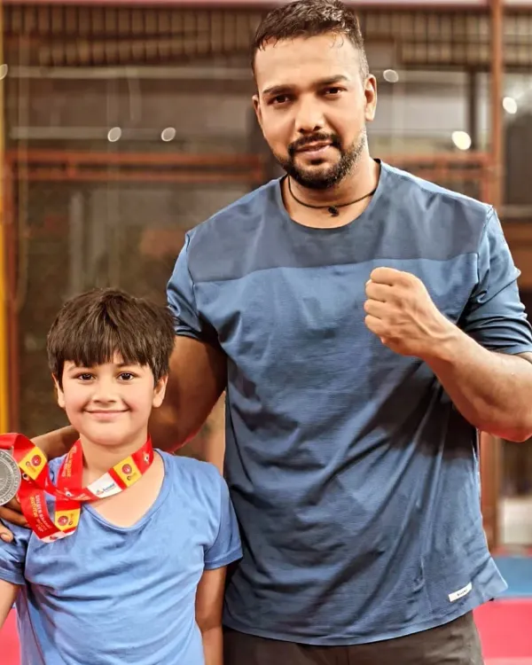 Posing with a young champion from my team. He earned his medal through hard work and dedication.