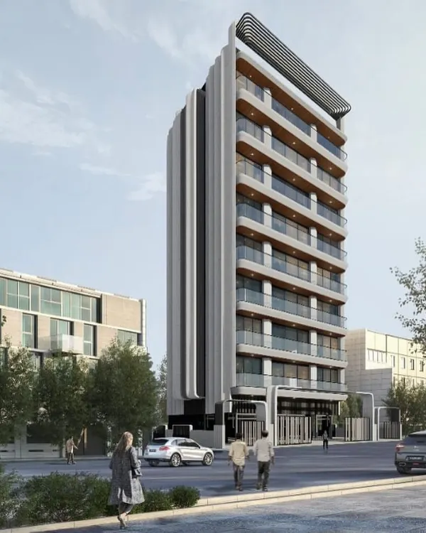 A render of the Irena Apartments, a residential redevelopment project. The design transforms a simple geometric block into a functional and elegant living space, with a facade defined by vertical fluted panels and soft, curved balconies.