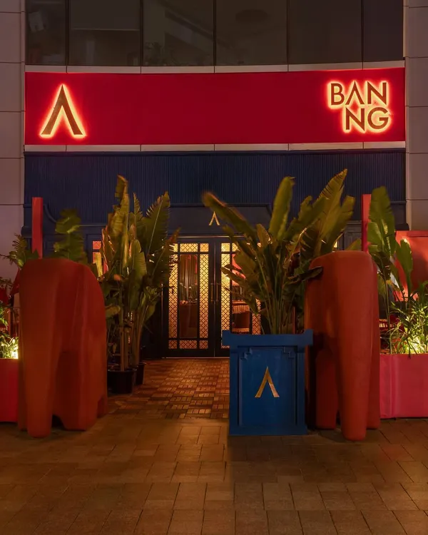 The exterior of BANNG, where bold red branding and sculptural elephant forms create an unmissable statement. This entrance is a portal from the corporate world of Gurugram into a fantastical Thai-inspired narrative.