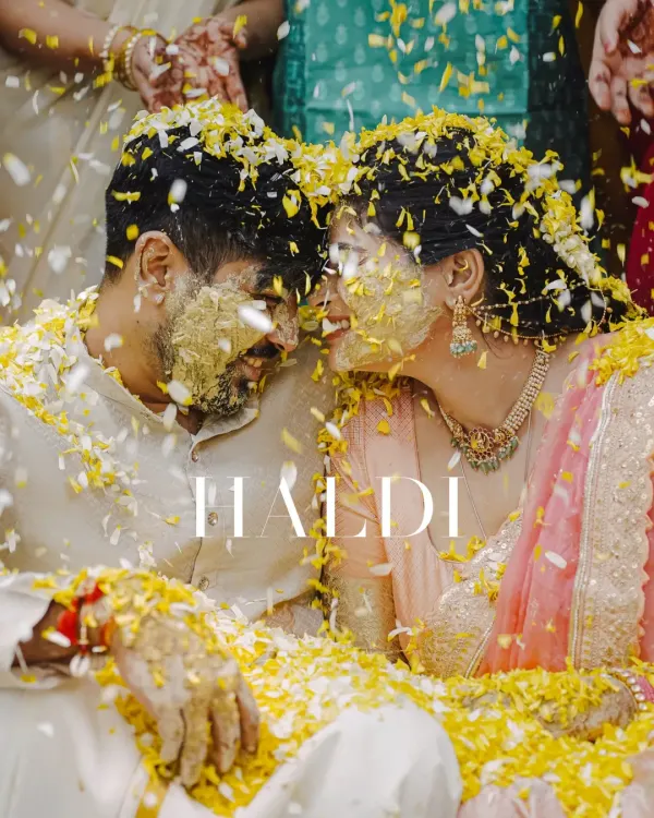 An intimate moment amidst the golden chaos. Here, covered in turmeric and flowers, the couple finds a quiet second that is entirely their own.