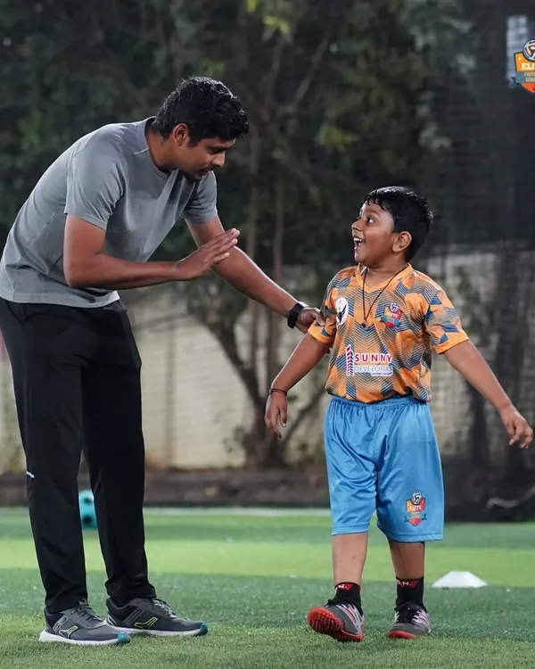 More than just a coach. A moment of connection and encouragement between a coach and a young player, capturing the supportive and positive environment we cultivate at our academy.
