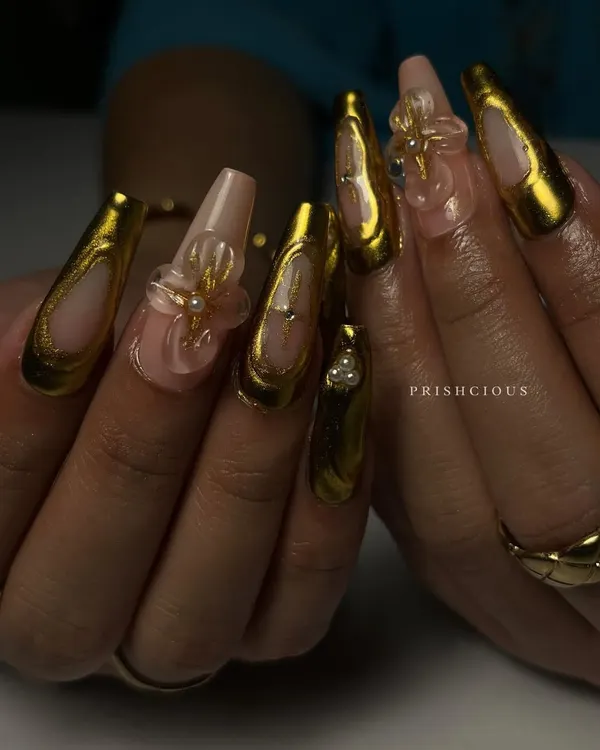 I am absolutely obsessed with how this set turned out. These are extra long coffin-shaped acrylic extensions with stunning 3D gold chrome detailing and delicate, clear floral charms. This is for when you want your nails to be the entire conversation.