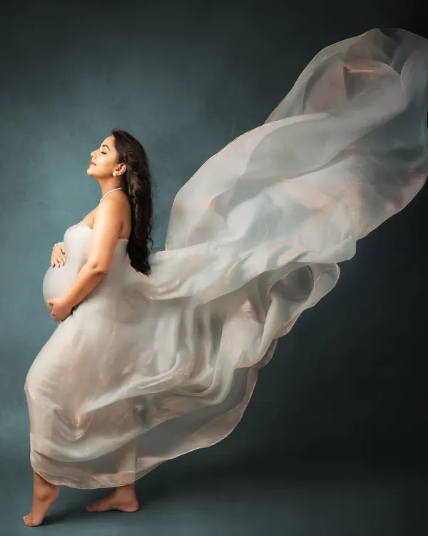 This is the magic of motherhood, captured in a single, flowing moment. In my studio, I use beautiful fabrics and soft lighting to create timeless portraits that feel like a work of art, celebrating your strength and grace.