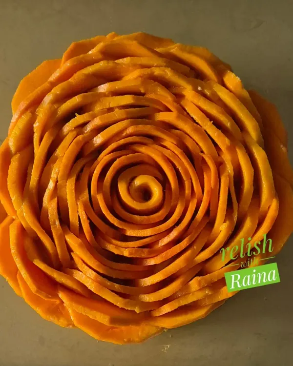 My seasonal Mango Cheesecake is a true celebration of summer. I use fresh Alphonso mangoes to create this eggless, melt-in-your-mouth dessert, topped with a beautiful rose design made from hand-sliced mangoes.