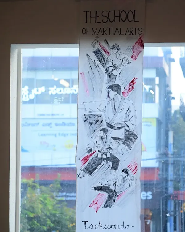 A handmade banner illustrating Taekwondo techniques, created by a student's family for our Black Belt ceremony. This personal touch highlights the deep involvement and support we receive from our community.