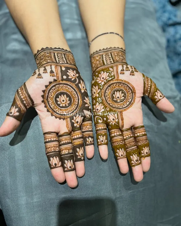 A beautiful mandala design with a lotus in the center. The pattern on each hand is slightly different, creating a unique look.