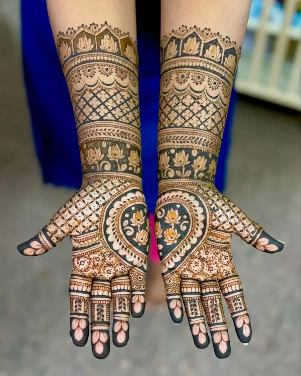 A gorgeous engagement mehendi for Supriya, featuring a heart-shaped design on the palms filled with lotus motifs.