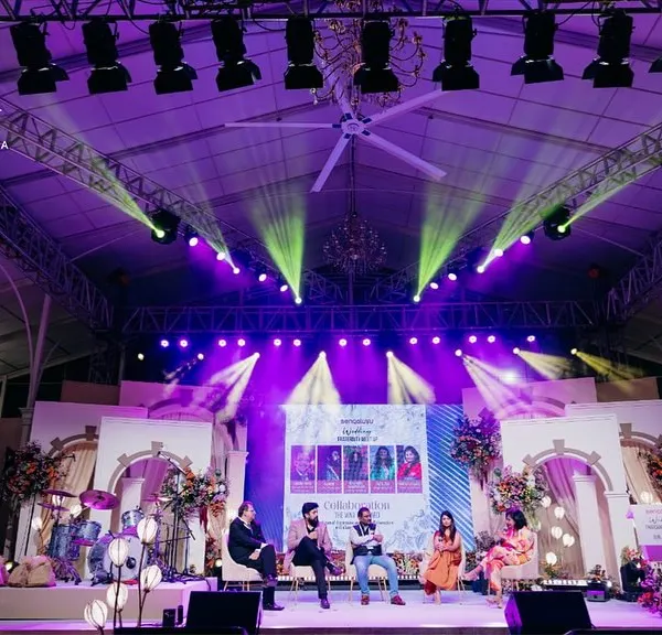 The main stage for the Bangalore Wedding Fraternity meetup. The design incorporated architectural elements and dramatic lighting to create a professional and engaging setting for panel discussions.