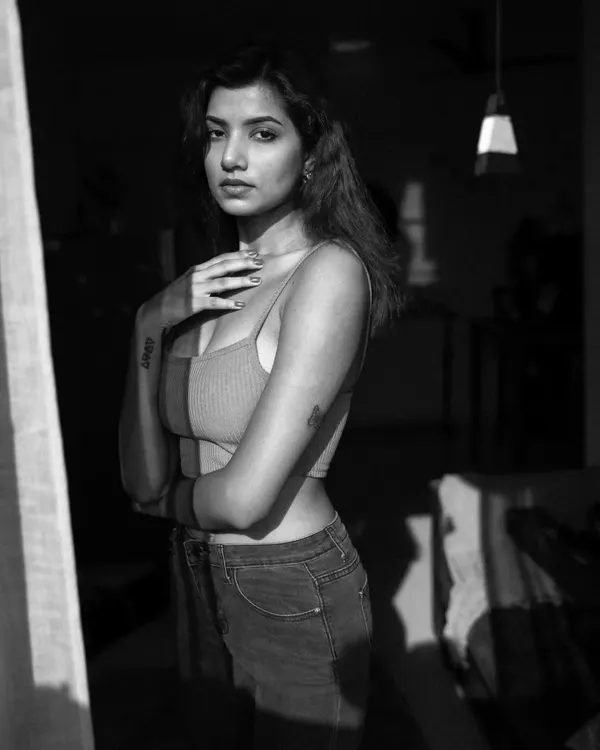 This black and white portrait was shot indoors at 9 AM using only natural light from a window. I intentionally used the curtains to cast interesting shadows on the model, adding depth and mood to the shot.
