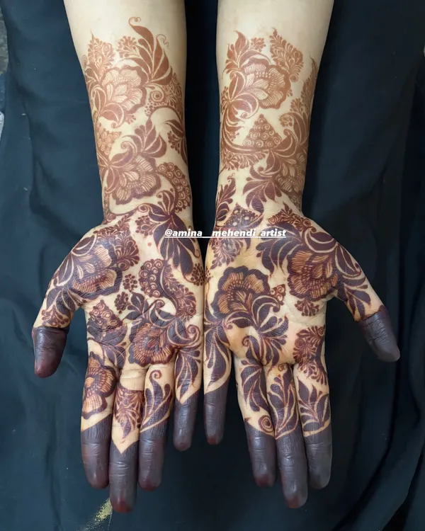 The stunning result of my natural henna after 48 hours. This bold floral design has developed into a deep, dark stain that covers the hands and forearms.