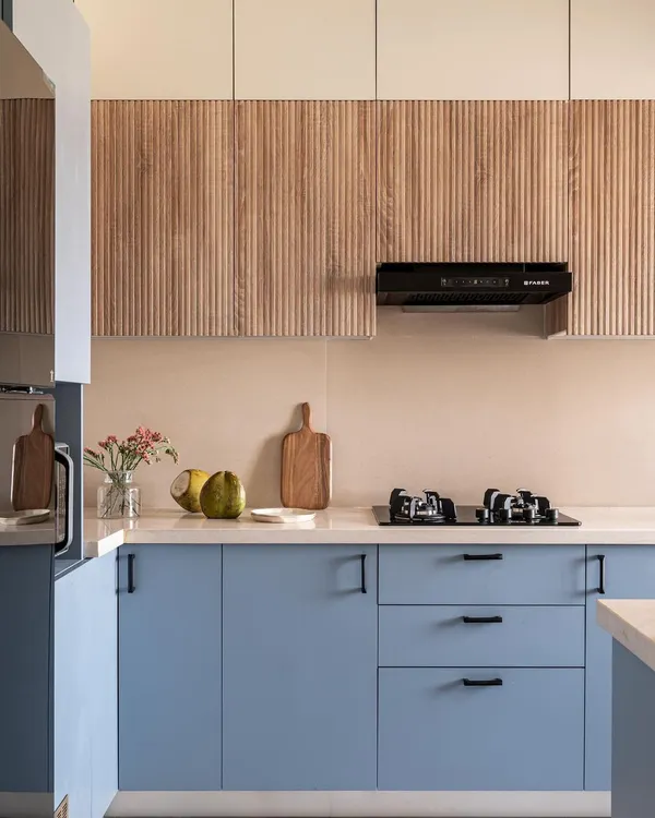 This custom modular kitchen from our Project Dolce perfectly captures my design philosophy. I combined serene periwinkle blue lower cabinets with warm, fluted wood panels on top to create a space that is modern, textured, and full of personality. It’s a kitchen that not only looks beautiful but is designed for the rhythms of daily life.